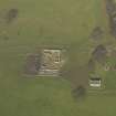 Oblique aerial view centred on the remains of the stable block with the garden house adjacent, taken from the SSW.