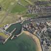 Oblique aerial view of Eyemouth centred on the harbour, taken from the NW.