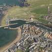 Oblique aerial view of Eyemouth centred on the harbour, taken from the W.