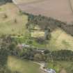 Oblique aerial view centred on the country house with the stable block and walled garden adjacent, taken from the N.