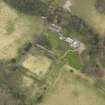 Oblique aerial view centred on the country house with the stable block and walled garden adjacent, taken from the SE.