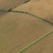 Oblique aerial view of the cropmarks of the rectilinear settlement enclosure, taken from the NNW