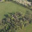 Oblique aerial view centred on the remains of the country house, taken from the NW.