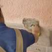 Mason preparing wall to take new false spout