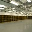 Interior view of NSWU 2 building packing hall with storage shelves/boxes.
