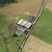 Oblique aerial view centred on the farmsteading, taken from the NE.