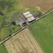 Oblique aerial view centred on the farmsteading, taken from the N.