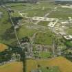 General oblique aerial view centred on the village with the airfield adjacent, taken from the SSW.