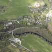 Oblique aerial view centred on the bridge with the village adjacent, taken from the SSW.