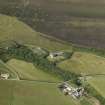 Oblique aerial view centered on the chambered cairn at Taversoe Tuck with Trumland House adjacent, taken from the SSE.