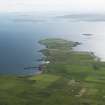 General oblique aerial view of the S end of Westray looking towards the Point of Huro, taken from the NE.