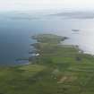 General oblique aerial view of the S end of Westray looking towards the Point of Huro, taken from the NE.