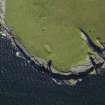 Oblique aerial view centred on the chambered cairn (south) on Holm of Papa Westray, taken from the NE.