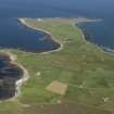 General oblique aerial view of the N end of North Ronaldsay looking towards Dennis Ness, taken from the SW.