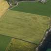 Oblique aerial view centred on the cropmarks of the broch at Bu, taken from the SW.