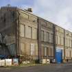 Office block. View of rear from W. Note remodelling. Probably earliest building surviving on site.