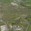 General oblique aerial view centred on the 'Gaydon' aircraft hangar with the USN base adjacent, taken from the SSW.