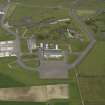 General oblique aerial view centred on the 'Gaydon' aircraft hangar with the USN base adjacent, taken from the S.
