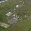 General oblique aerial view centred on the 'Gaydon' aircraft hangar with the USN base adjacent, taken from the SE.