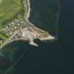 Oblique aerial view centred on the remains of the shipyard, taken from the SW.