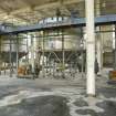 Interior.  View across the ground floor in the charge pulping and blending house, showing the lower part of the storage tanks.