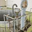 Interior.  Detail of gauge stand and hopper at edge of vat in VAT house.