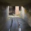 View through tunnel under earth mound to entrance to burning sorting house.