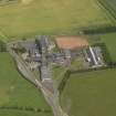 Oblique aerial view centred on the school/community centre with the primary school adjacent, taken from the SSW.