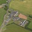 Oblique aerial view centred on the school/community centre with the primary school adjacent, taken from the SE.