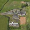 Oblique aerial view centred on the school/community centre with the primary school adjacent, taken from the E.
