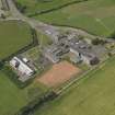 Oblique aerial view centred on the school/community centre with the primary school adjacent, taken from the NE.