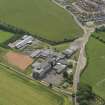 Oblique aerial view centred on the school/community centre with the primary school adjacent, taken from the NW.
