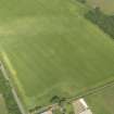 Oblique aerial view of the cropmarks of the enclosure, pits and pit alignment, taken from the SSE.