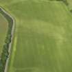 Oblique aerial view of the cropmarks of the enclosure, pits and pit alignment, taken from the SE.