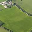 Oblique aerial view of the cropmarks of the enclosure, pits and pit alignment, taken from the N.