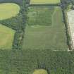 Oblique aerial view of the cropmarks of the barrow, field boundaries and pits, taken from the WSW.