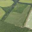 Oblique aerial view of the cropmarks of the barrow, field boundaries and pits, taken from the WSW.