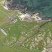 Oblique aerial view centred on Hynish farm steading with Hynish farmhouse adjacent, taken from the SSW.