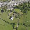 Oblique aerial view of Whithorn Parish Church and priory, taken from the NW.