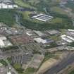 Oblique aerial view centred on the industrial estate with the M74 extension work adjacent, taken from the SW.
