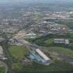 General oblique aerial view centred on the steel works with the motorway extension works adjacent, taken from the E.