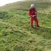 View of Mr Ian Parker (RCAHMS) using differential GPS to survey a late 19th century excavation trench at the W end of the timber-laced fort.