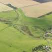 Oblique aerial view centred on the railway bridge with the remains of the railway adjacent, taken from the NE.