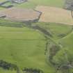 Oblique aerial view centred on the railway bridge with the remains of the railway adjacent, taken from the N.