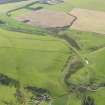 Oblique aerial view centred on the railway bridge with the remains of the railway adjacent, taken from the N, Catcune to Tynehead to Falahill section