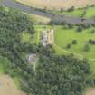 Oblique aerial view centred on the country house with the stable block adjacent , taken from the NNW.