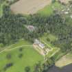Oblique aerial view centred on the country house with the stable block adjacent , taken from the S.