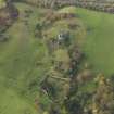 Oblique aerial view centred on the remains of the country house, taken from the E.