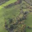 Oblique aerial view centred on the remains of the country house, taken from the NE.