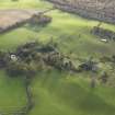 Oblique aerial view centred on the remains of the country house, taken from the NW.